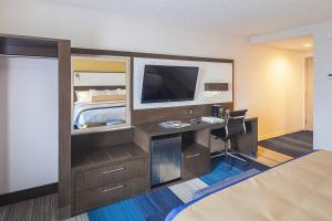 a hotel room with a desk and a bed at Southbank Hotel by Marriott Jacksonville Riverwalk in Jacksonville