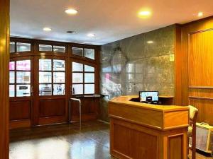 a lobby with a desk in a building at Departamento Plaza in Bahía Blanca