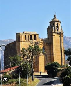un gran edificio de ladrillo con una torre de reloj en una colina en Casa Dolare a 4 kilometros de Laguardia, en Leza