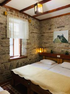a bedroom with two beds and a window at Guest House and Hostel VAL-MAR in Gjirokastër