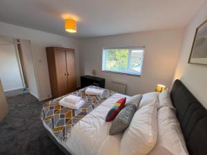 a bedroom with a bed with a couch and a window at Tree View Apartment in Chesterton