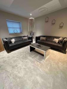 a living room with two couches and a coffee table at Cosy newly renovated 3 bedroom house - Town centre Horncastle in Lincolnshire