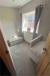a small room with a bed and a window at Cosy newly renovated 3 bedroom house - Town centre Horncastle in Lincolnshire