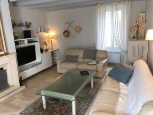 a living room with a couch and a coffee table at Maison Althea Rosea - 3 chambres et piscine in Nieulle-sur-Seudre