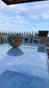 a table with a bowl on top of a swimming pool at Mama’s Sunshine Garden Villa in Áyios Ilías