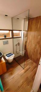 a bathroom with a toilet and a glass wall at A&A Luxury Apartments Preveza in Preveza