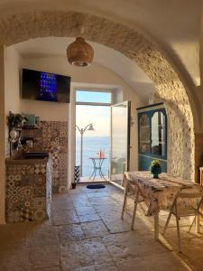 a kitchen with a table and a view of the ocean at Nonna Libera Vista Mare in Rodi Garganico