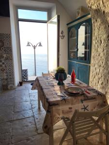 a table in a room with a view of the ocean at Nonna Libera Vista Mare in Rodi Garganico