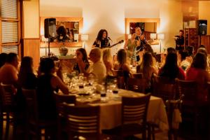 a group of people sitting at tables in a restaurant at Serra Alta Hotel in São Bento do Sul +55 photos