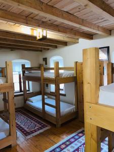 a room with three bunk beds in a house at Guest House and Hostel VAL-MAR in Gjirokastër