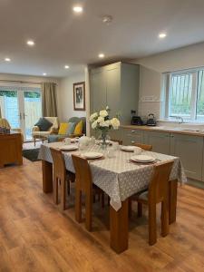 a dining room table with chairs and a kitchen at The Fort in Derrylin