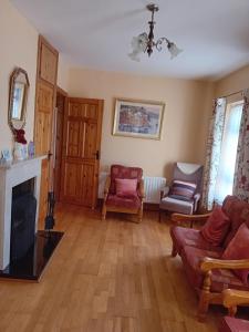 a living room with a couch and a fireplace at Causeway Country Lodge in Causeway