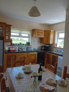 a kitchen with a table with a bottle of wine at Causeway Country Lodge in Causeway