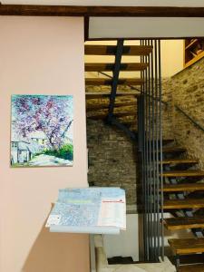 a staircase in a building with a painting on the wall at Guest House and Hostel VAL-MAR in Gjirokastër