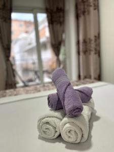 a purple teddy bear sitting on a pile of towels at Pearl Apartments in Budva
