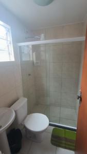 a small bathroom with a toilet and a shower at Pousada do Gil in Teresópolis +10 photos