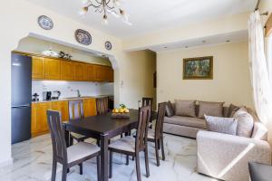 a kitchen and living room with a table and chairs at Remezzo Cottage in Skopelos Town