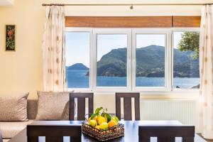 a living room with a table and a window at Remezzo Cottage in Skopelos Town