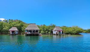 two gazebos in the middle of the water at El Clandestino in Bocas del Toro