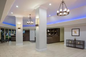 a lobby with columns and chandeliers in a building at Four Points by Sheraton Orlando International Drive in Orlando