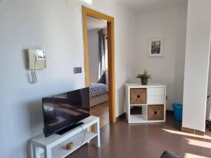 a living room with a flat screen tv on a dresser at Casa as Neves -3B. Gran Ventanal in Malpica