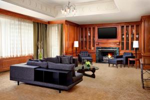 a living room with a couch and a fireplace at The Westin Calgary in Calgary
