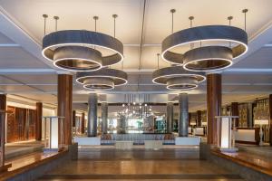 a lobby with chandeliers and tables in a building at Sheraton Fiji Golf & Beach Resort in Denarau