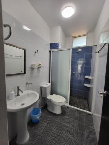 a bathroom with a toilet and a sink at Casa Puerto Bonito & Private Coworking in Puerto Escondido