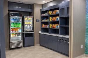 a pantry with two refrigerators and drinks at SpringHill Suites by Marriott Slidell in Slidell