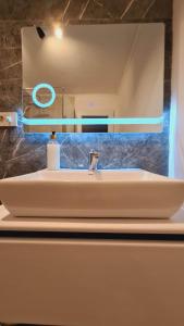 a white sink in a bathroom with a mirror at Painte's Home in Pristina