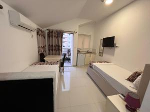 a small room with two beds and a tv at Pearl Apartments in Budva