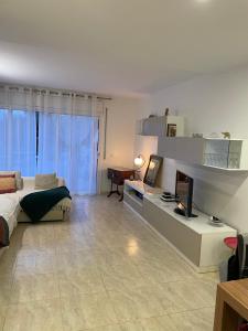 a large living room with a bed and a television at Empordà Country House in Borrassá