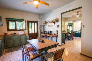 a kitchen and dining room with a table and chairs at The Village House in Volos