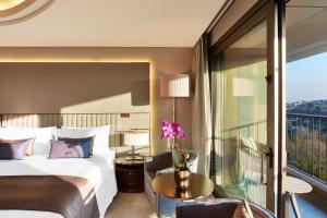 a hotel room with a bed and a balcony at The St. Regis Istanbul in Istanbul