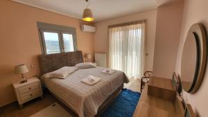 a bedroom with a bed and a large mirror at Seaview Villa in Néa Epídhavros +24 photos