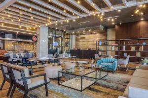 a lobby with tables and chairs and a library at Four Points by Sheraton Puebla in Puebla
