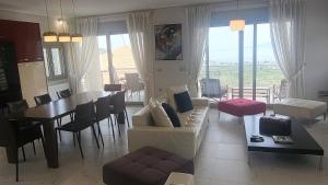 a living room with a couch and a dining room at Seaview Villa in Néa Epídhavros