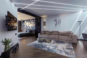 a living room with a couch and a table at Odesa Pearl Apartments in Odesa