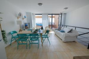 a living room with a table and chairs and a couch at Casa Castillo in Costa de Antigua