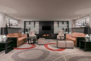 a living room with couches and a fireplace at Sheraton Bucharest Hotel in Bucharest