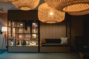 a room with two chandeliers and a shelf with books at Fairfield by Marriott Gifu Gujo in Gujo