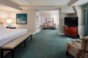 a hotel room with a bed and a flat screen tv at Delta Hotels by Marriott Bessborough in Saskatoon