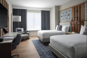 a hotel room with two beds and a desk at Austin Marriott South in Austin