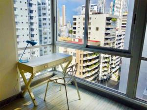 a desk and a chair in front of a window at Sublime Apartment City Center - PH Quartier Atlapa in Panama City