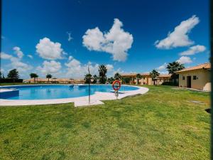 a swimming pool with a no swimming sign in the grass at DeCapi House in Sanlúcar de Barrameda