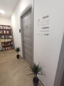 a hallway with a door and two potted plants at A casa di Lina in Olbia