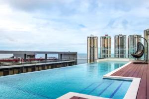 a swimming pool on the roof of a building with tall buildings at Sublime Apartment City Center - PH Quartier Atlapa in Panama City