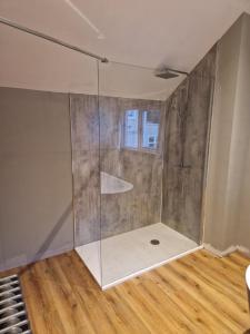 a shower with a glass door in a room at Blackberry Barn in Ballymena