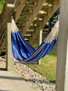 a couple of blue hammocks hanging under a bridge at __Kristian’s Palace Your Beach Getaway in Kill Devil Hills