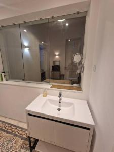 a bathroom with a sink and a mirror at Prime Fully Equipped Studio 2 Ideal Base to Explore Malta in Il-Furjana +16 photos